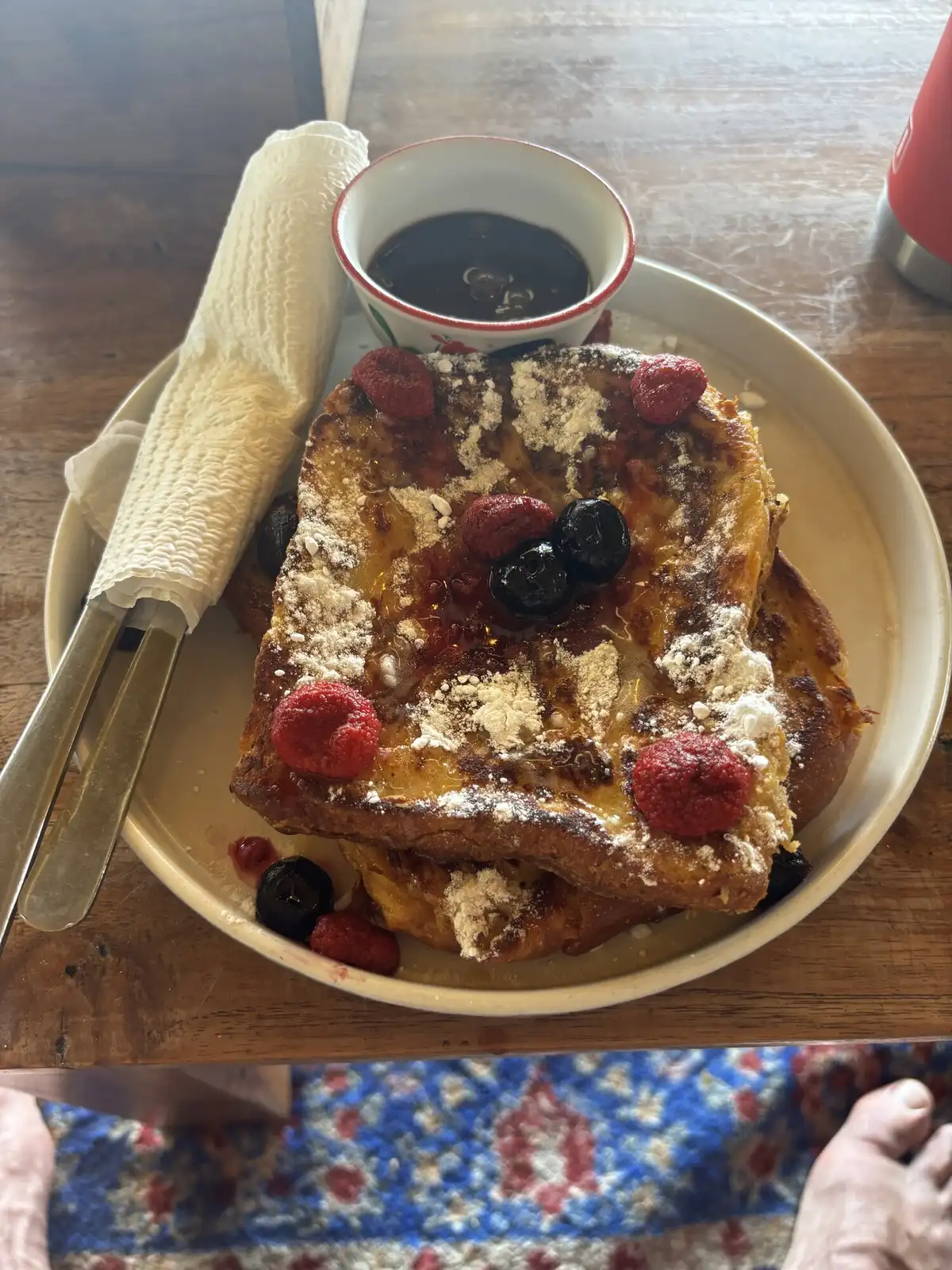 French toast stacked with fresh berries, powdered sugar and maple syrup at the Bali airport guesthouse