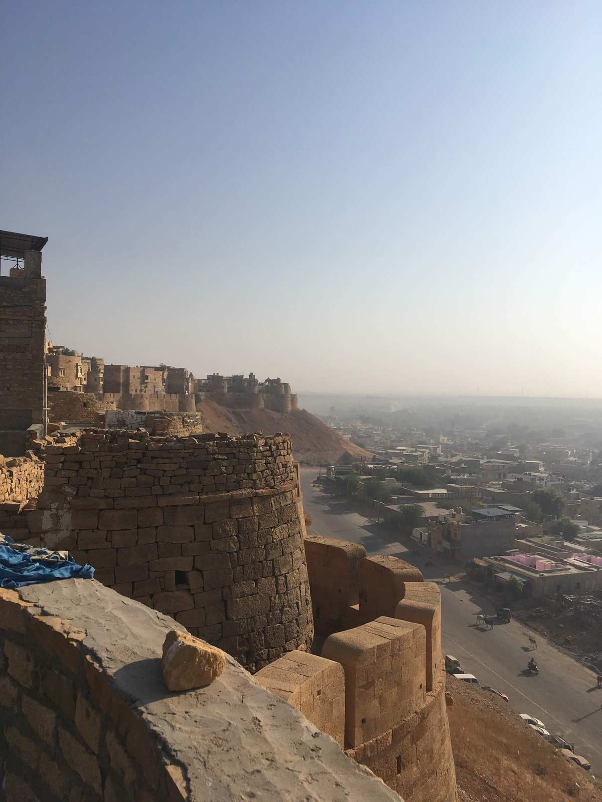 Golden sandstone battlements of Jaisalmer Fort overlooking the desert city below